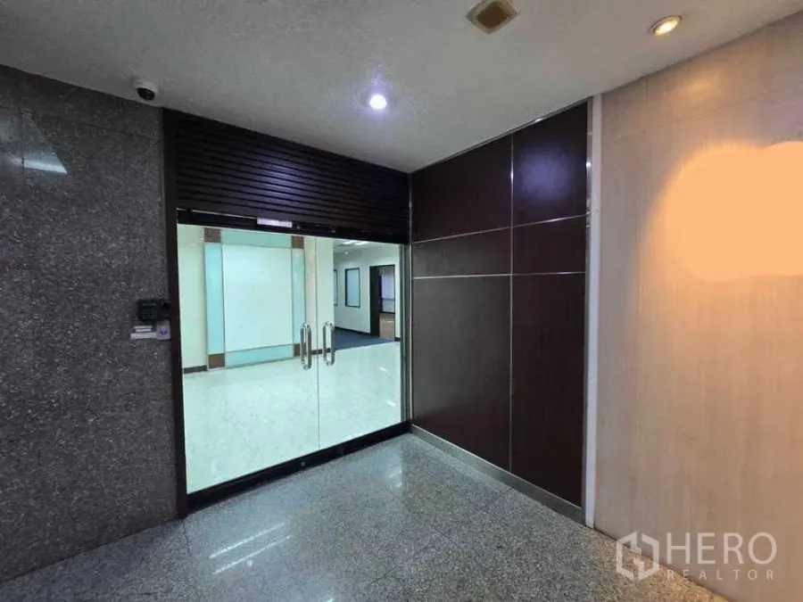 Office Space for rent in Khlong Toei, Bangkok - Glass double-door office entrance with polished corridor in a Khlong Toei building.