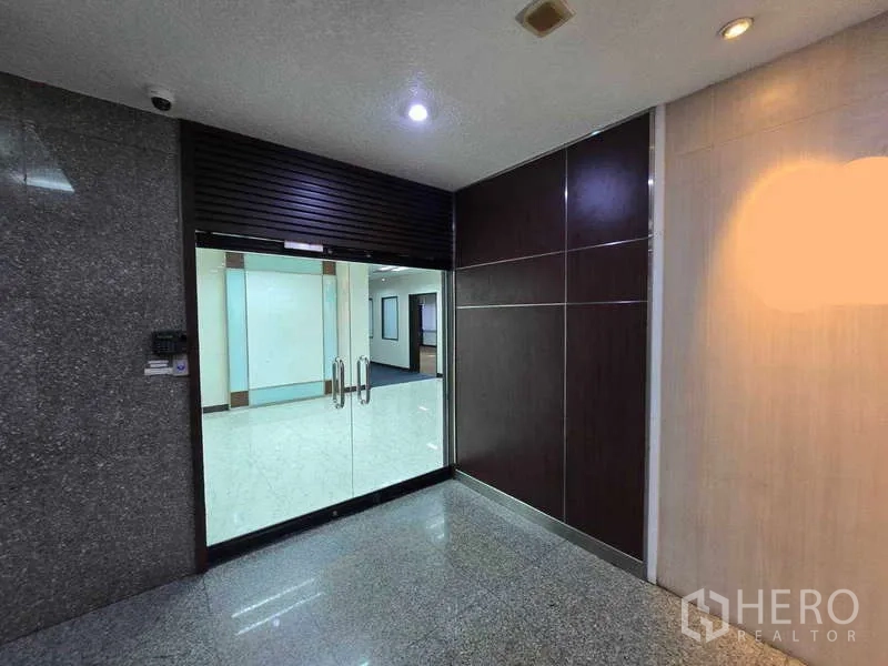 Office Space for rent in Khlong Toei, Bangkok - Glass double-door office entrance with polished corridor in a Khlong Toei building.