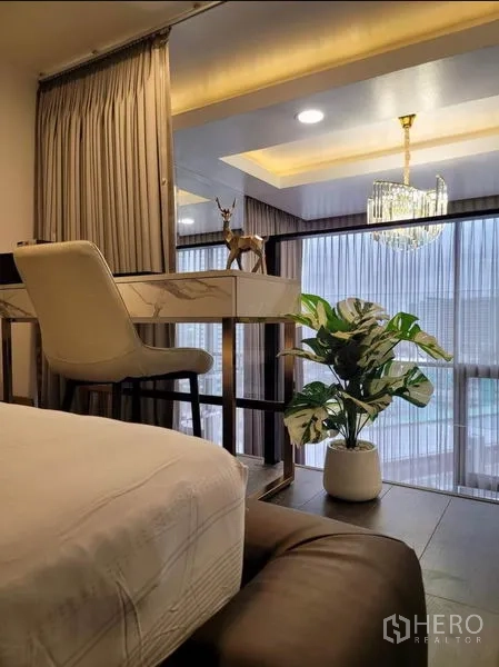 คอนโด ให้เช่าในChatuchak, Bangkok - มุมทำงานบนชั้นลอย โต๊ะท็อปหินอ่อน เก้าอี้บาร์ โคมระย้า และต้นไม้กระถาง มองลงสู่ห้องนั่งเล่น