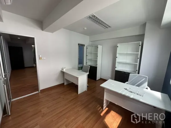 Office Space for rent in Watthana, Bangkok - Manager’s office showing two desks, storage cabinets and glass door entry.