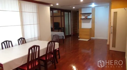 Condominium for rent or sale in Sathon, Bangkok - Long living–dining room with hardwood floors, recessed lighting, and built-in shelves.