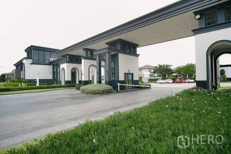 Detached House for rent in Bang Bo, Samut Prakan - Grand gated entrance of the housing estate with security checkpoint.