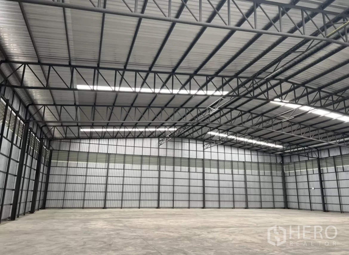 Warehouse for rent in Lat Lum Kaeo, Pathum Thani - Spacious warehouse interior with an 8m high steel‑truss roof, roof lights, and smooth concrete floor.