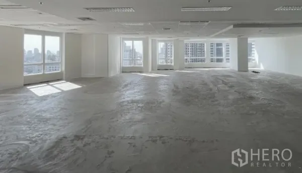 Office Space for rent - Unfurnished corner office level showcasing city skyline views through wide windows.