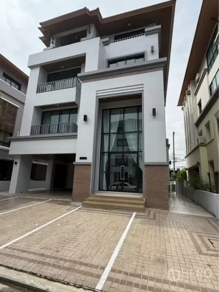 Home Office for rent in Wang Thonglang, Bangkok - Modern four-storey home office exterior with tall glass entrance and marked parking bays.