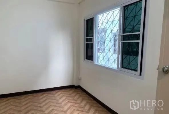 Home Office for rent in Sathon, Bangkok - Compact room with a window fitted with security grilles.