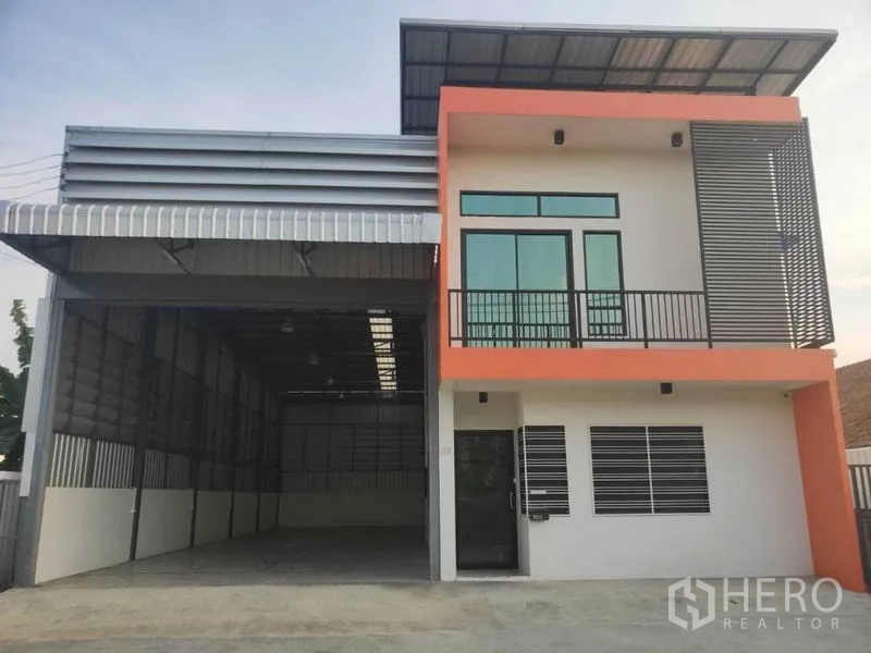Warehouse for rent in Lam Luk Ka, Pathum Thani - Front view showing open high-bay loading area and glass-fronted office.