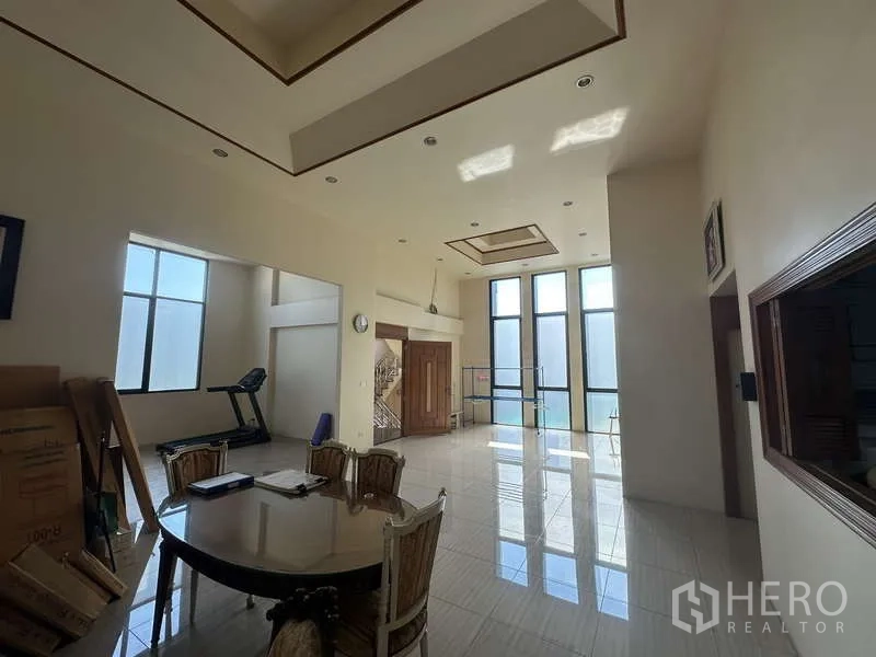 Home Office for sale in Lam Luk Ka, Pathum Thani - Grand great room with soaring ceilings, full-height windows and a staircase entry