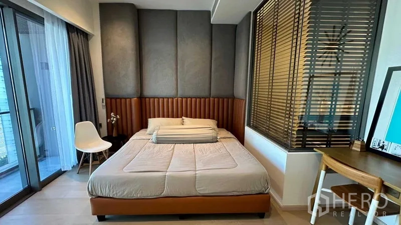 Condominium for sale - Bedroom media wall with floating shelves, small TV and cabinet.