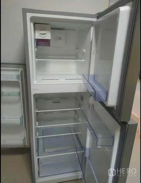 Detached House for rent in Wang Thonglang, Bangkok - Open two-door refrigerator showing clean shelves and freezer compartment.