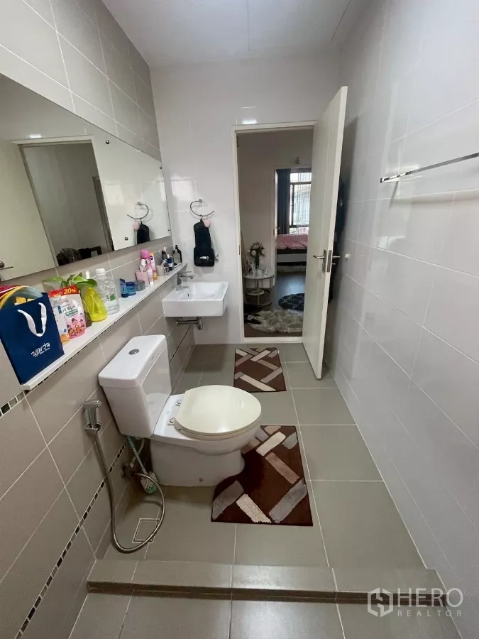 Detached House for sale in Bang Phli, Samut Prakan - Bathroom reverse angle with long mirror and tiled floor leading to bedroom.
