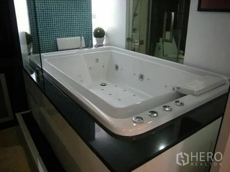 คอนโด ให้เช่าหรือขายในWatthana, Bangkok - ภาพระยะใกล้ของอ่างจากุซซีก่อ build-in ขนาดใหญ่ พร้อมปุ่มควบคุมและผนังกระเบื้องโมเสก