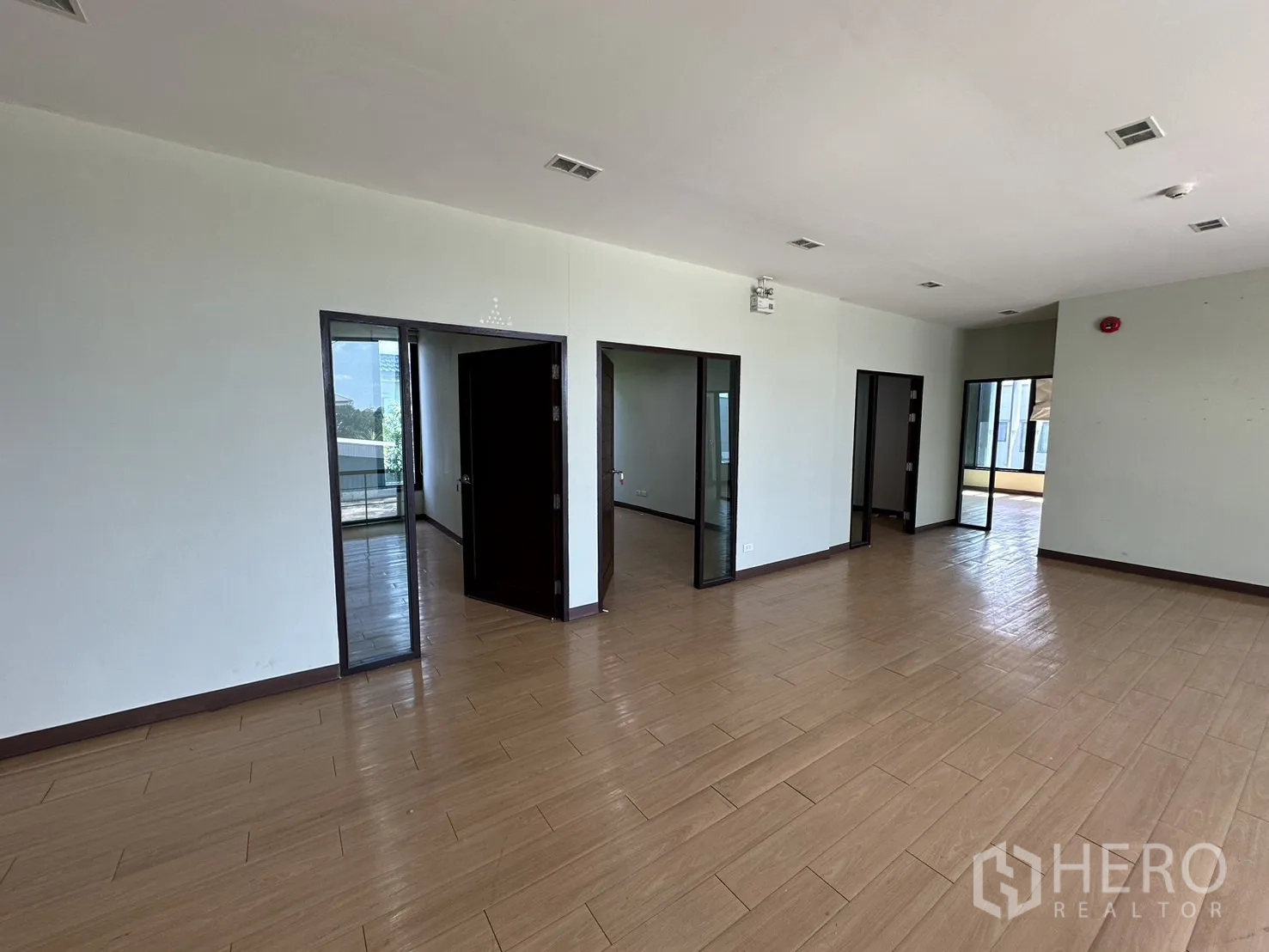 Home Office for rent in Prawet, Bangkok - Second-floor corridor leading to several glass-front offices.
