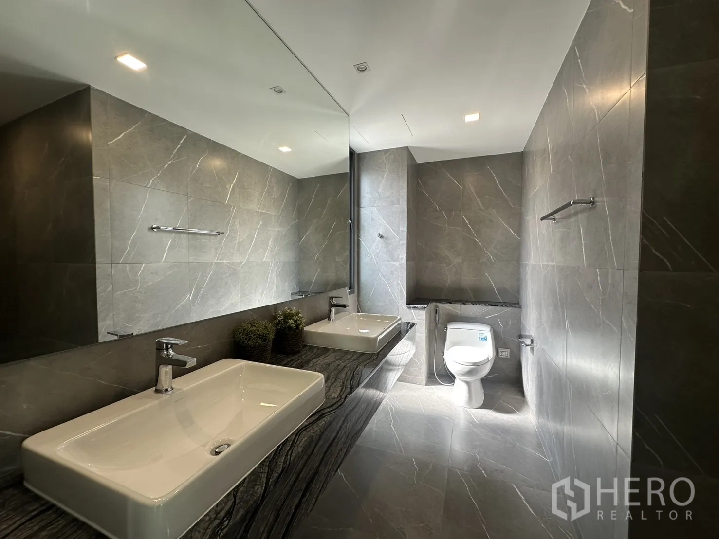 Home Office for rent or sale in Suan Luang, Bangkok - Modern bathroom with double rectangular sinks and large mirror.