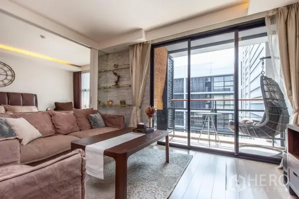 คอนโด ให้เช่าในWatthana, Bangkok - พื้นที่นั่งเล่นเปิดสู่ระเบียงพร้อมชิงช้าตาข่ายและวิวเมือง