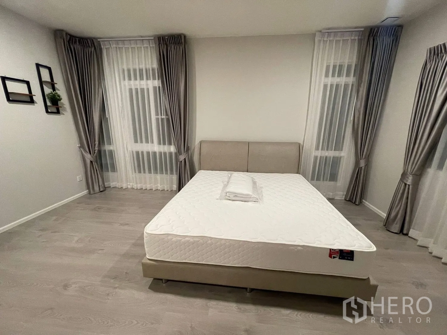 Detached House for rent in Prawet, Bangkok - Spacious bedroom with large windows, sheer curtains, and double bed.