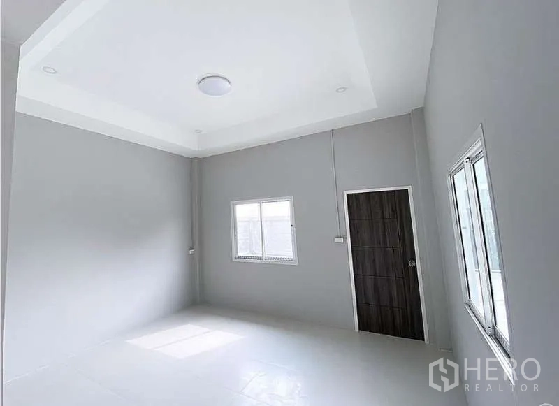 Warehouse for sale in Pathum Thani - Large office or meeting room with recessed ceiling, windows and dark wood door.