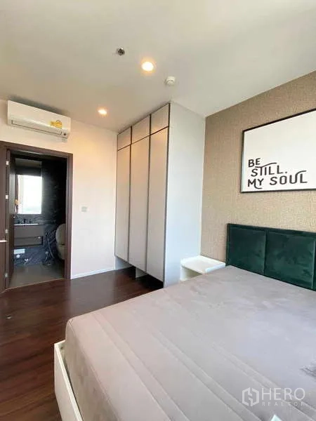 Condominium for rent - Primary bedroom with built‑in wardrobe, air conditioner and ensuite access.