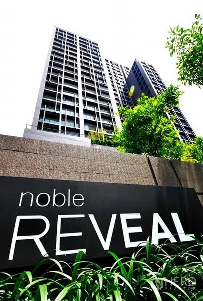 Condominium for rent or sale in Watthana, Bangkok - Noble Reveal high‑rise condominium exterior with project signage and green trees.
