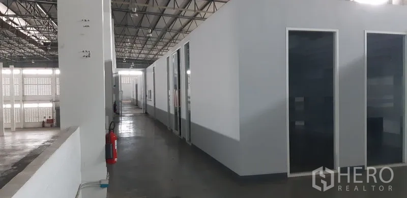 Factory for rent in Lat Krabang, Bangkok - Internal office block with glass-fronted rooms along the production floor.