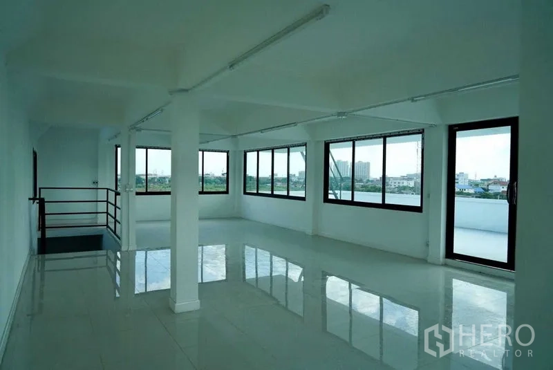 Office Space for sale in Khan Na Yao, Bangkok - Four-storey white office building with gated entrance on a quiet street.