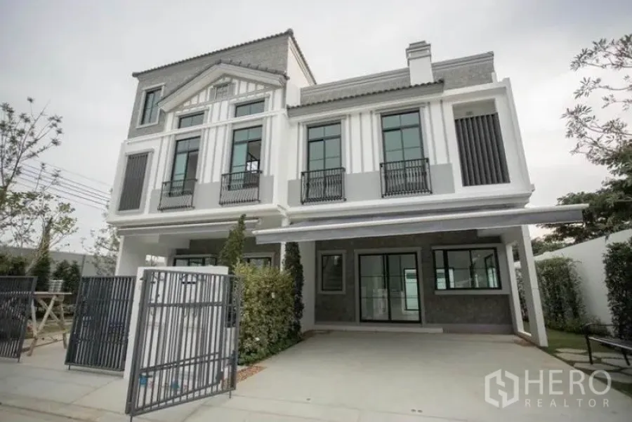 Townhouse for rent in Bang Phli, Samut Prakan - Modern three-storey townhouse exterior with gated entrance and covered parking.