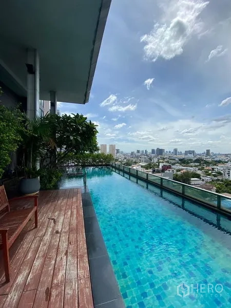 Condominium for rent or sale - Rooftop swimming pool with wooden deck, greenery and panoramic skyline.