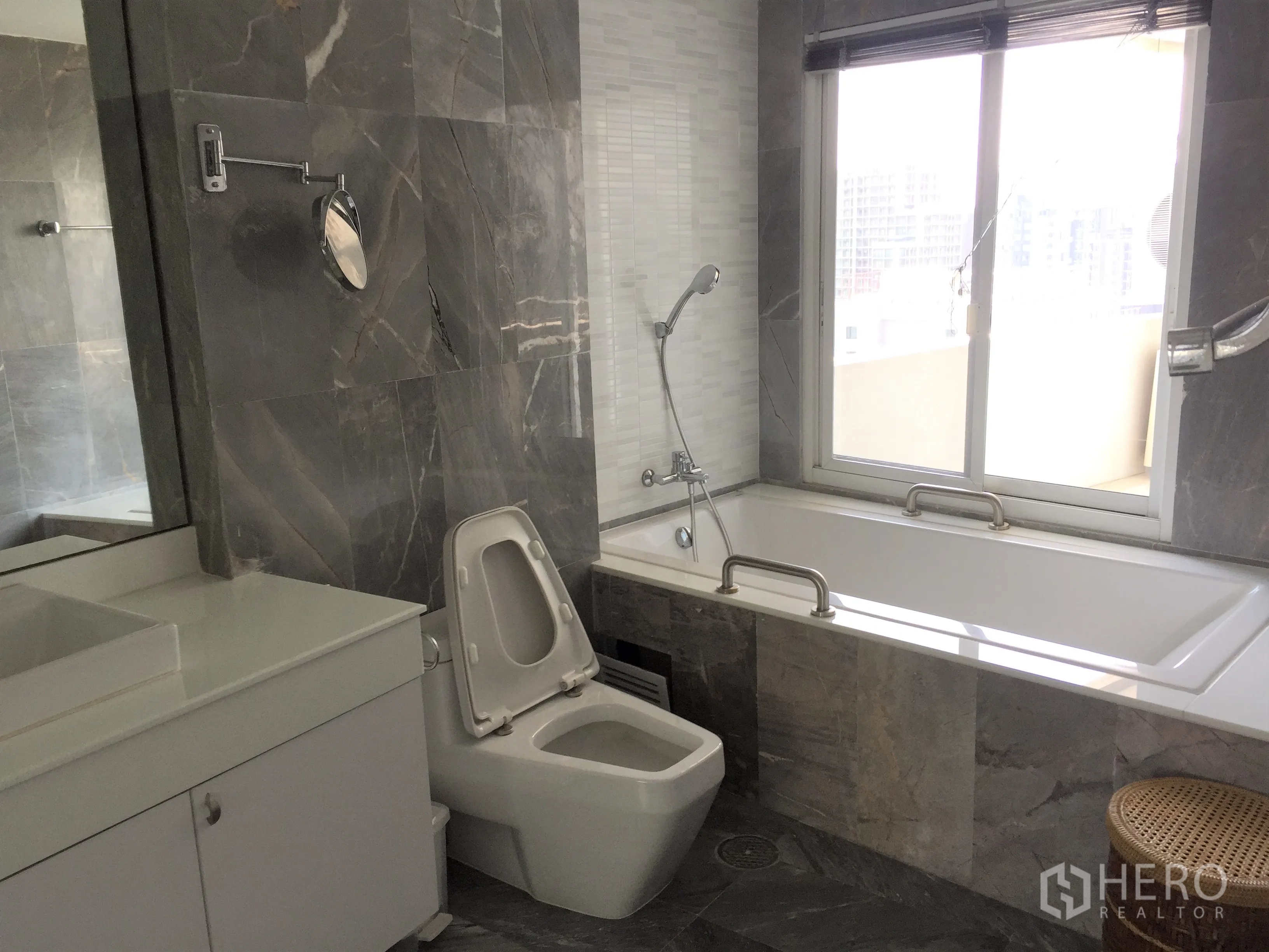 คอนโด ให้เช่าในWatthana, Bangkok - ห้องน้ำหินอ่อน อ่างอาบน้ำริมหน้าต่าง ฝักบัวมือถือ และเคาน์เตอร์อ่างล้างหน้า