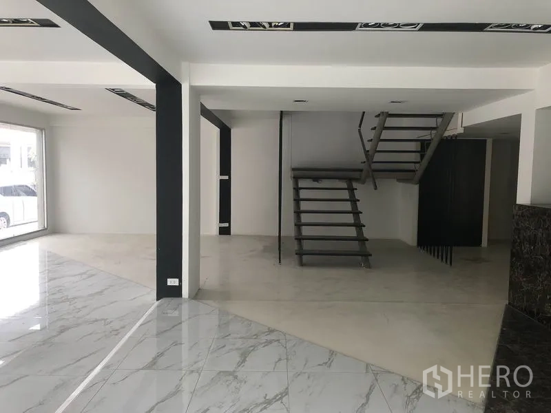 零售空间 出租在Watthana, Bangkok - 灵活零售楼层，悬浮式金属楼梯与开放式夹层空间。