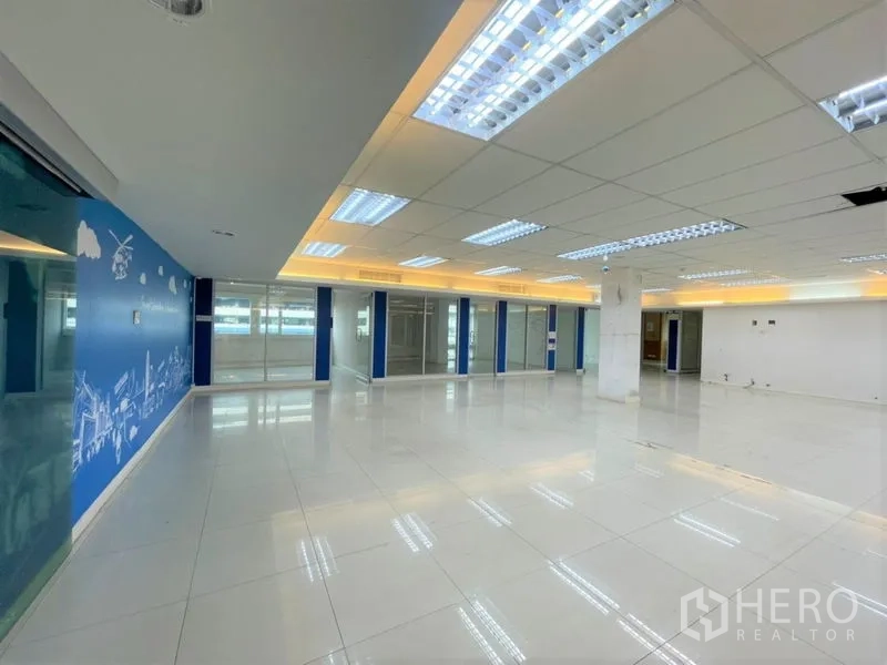 Office Space for rent in Chatuchak, Bangkok - Wide office area with blue graphic feature wall, grid LED lighting, and glass offices.