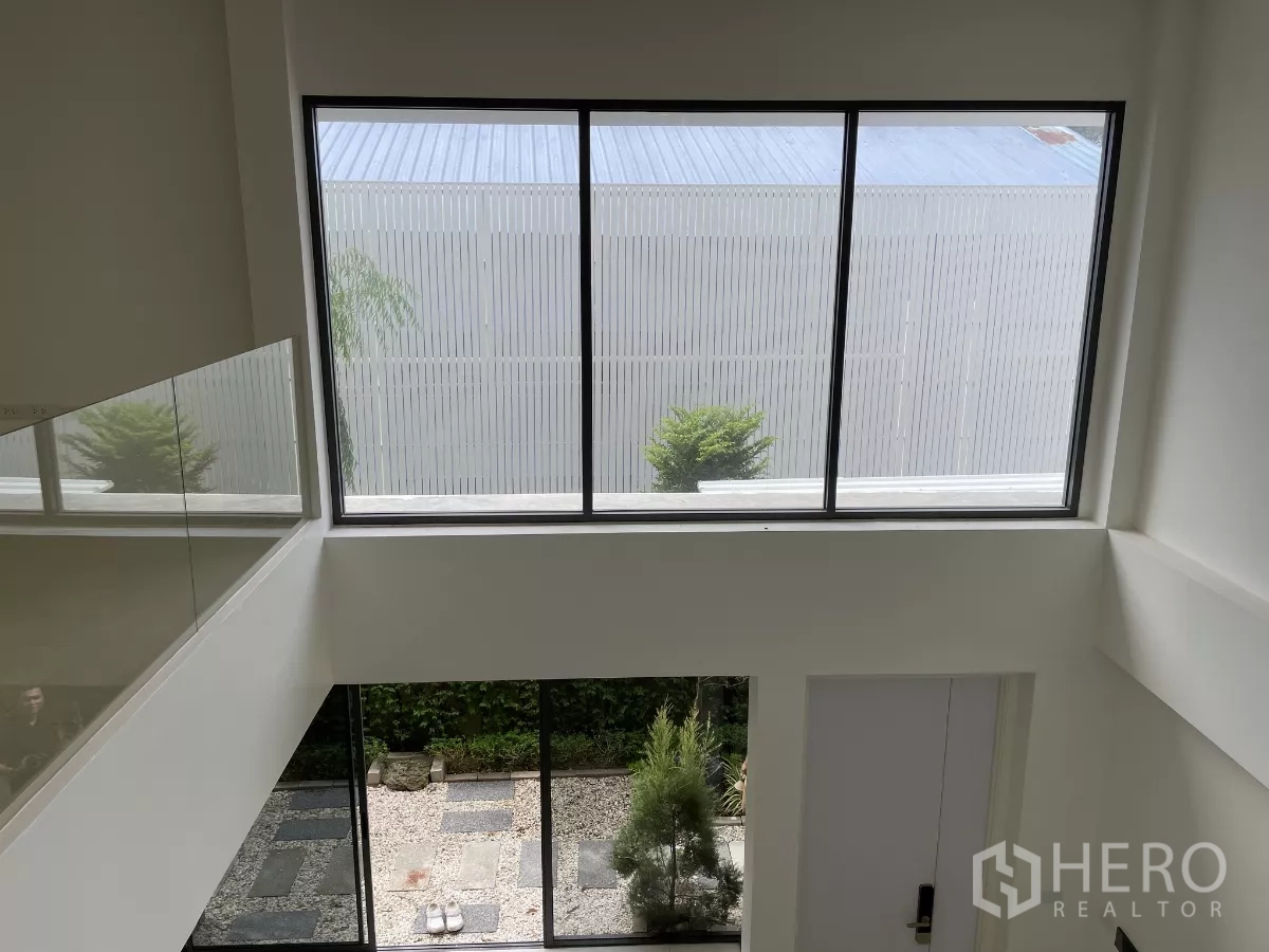 Home Office for rent in Don Mueang, Bangkok - View from mezzanine showing tall window and courtyard garden below.