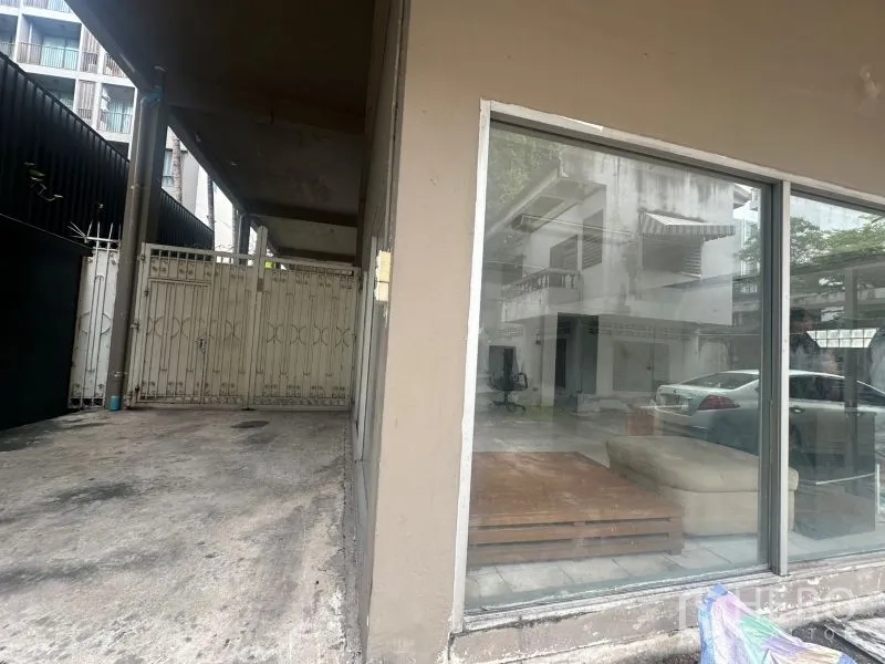 Office Space for rent - Covered driveway and roller gate beside glass-walled ground floor