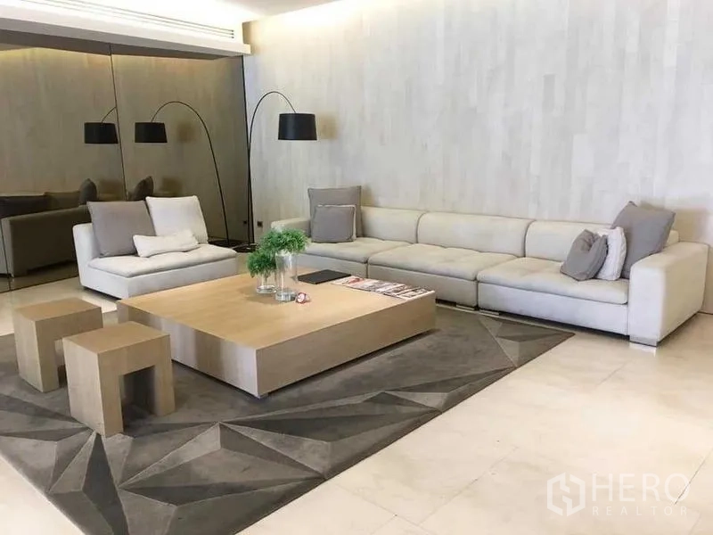 Condominium for rent in Bang Rak, Bangkok - Stylish condominium lobby lounge with long sectional sofa and wood coffee table.