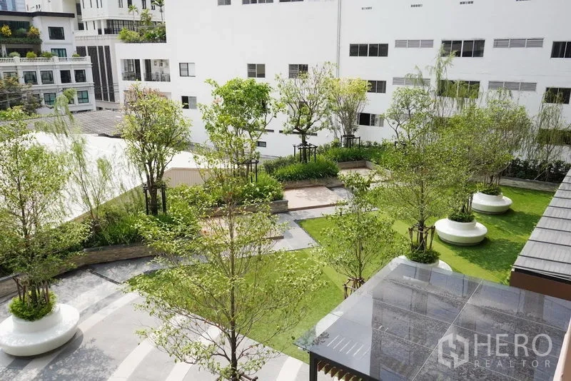 公寓 出租在Pathum Wan, Bangkok - 公寓景观花园庭院，绿树草坪与休憩座椅