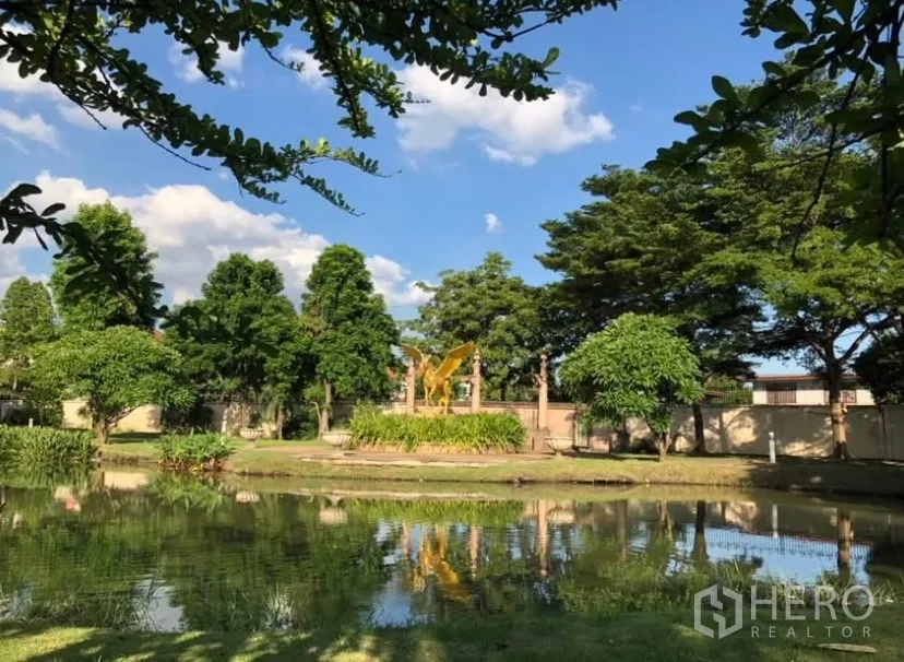 独立式住宅 出租或出售在Lat Phrao, Bangkok - 社区公园与池塘，绿树倒影与蓝天。