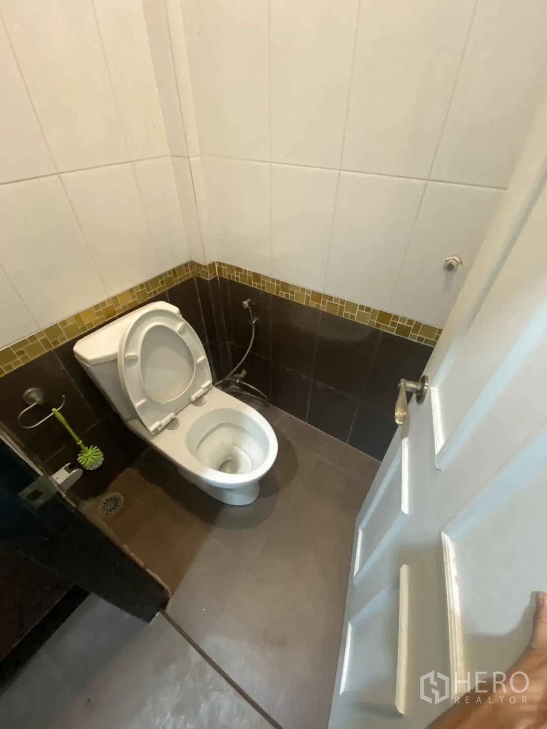 Shophouse for rent in Bang Rak, Bangkok - Separate toilet room with bidet spray and tiled walls and floor.