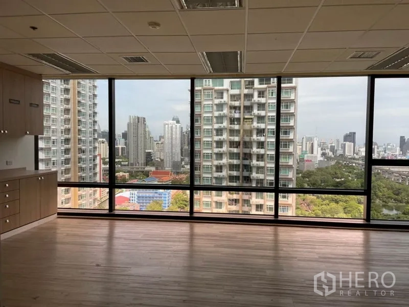 Office Space for rent - Room with wood flooring, built-in cabinets and panoramic windows facing nearby high-rises.