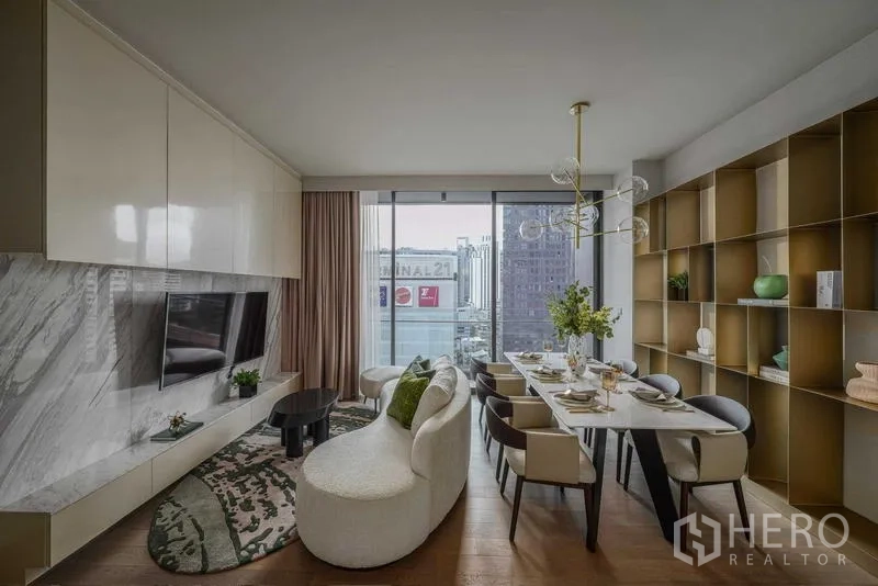 Condominium for rent - Another angle of the living–dining room showing big windows and the city skyline.