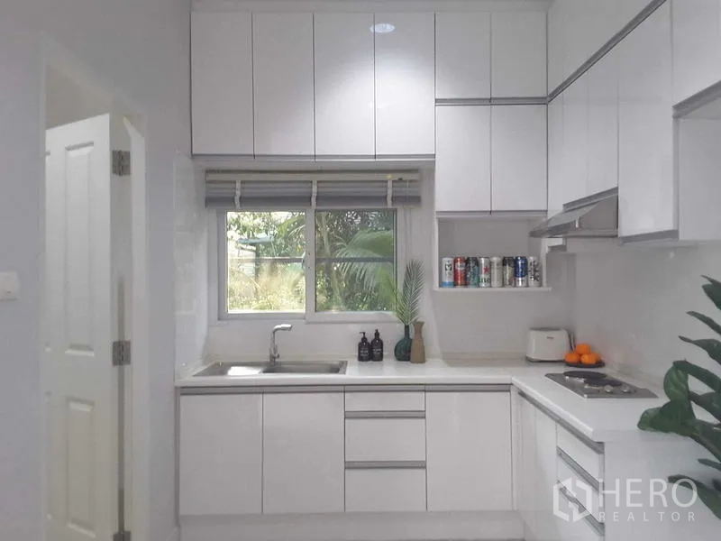 บ้าน ให้เช่าในLam Luk Ka, Pathum Thani - ห้องครัวบิวท์อินสีขาวสมัยใหม่ พร้อมตู้แขวน หน้าต่าง และเตา