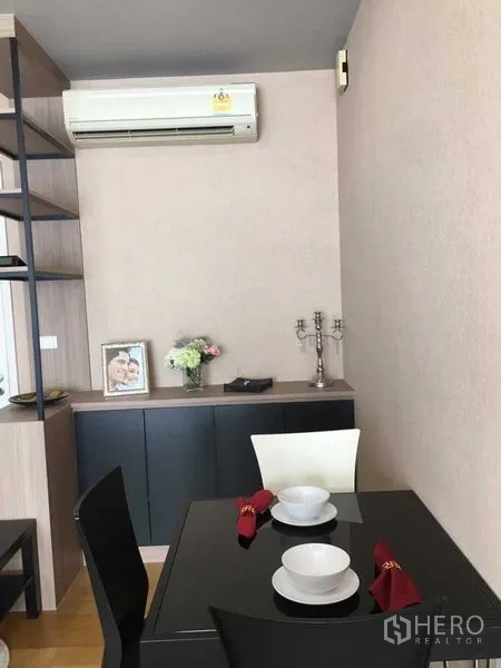 Condominium for sale in Khlong San, Bangkok - Dining nook with built-in cabinet and wall-mounted air conditioner.