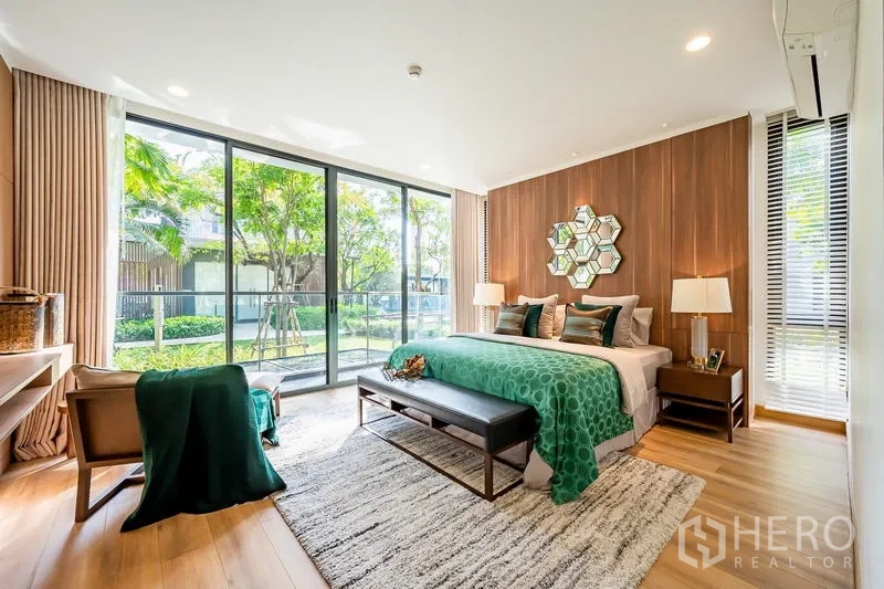 Condominium for sale - Master bedroom with wide windows, bench seating and green accents opening to lush views.
