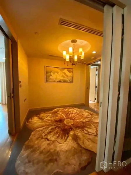 คอนโด ให้เช่าในKhlong Toei, Bangkok - โถงทางเข้าเพดานโคมไฟและพรมลายดอกไม้ขนาดใหญ่ นำไปสู่ห้องนอน