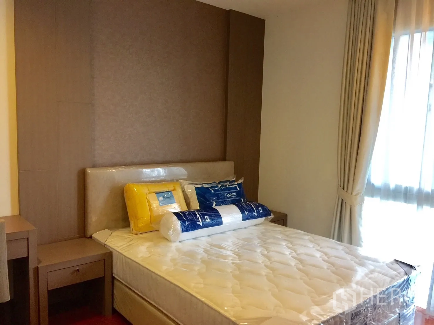 Condominium for rent in Watthana, Bangkok - Cozy bedroom with upholstered headboard, new mattress, bedside tables and soft curtains by the window.