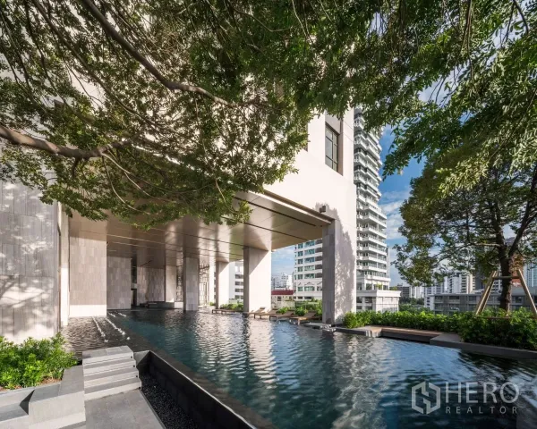 Condominium for rent in Watthana, Bangkok - Leafy outdoor swimming pool with city skyline views at a high-rise condominium in Watthana.