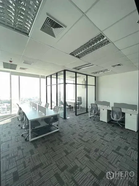 Office Space for rent in Bang Kapi, Bangkok - Fitted workstations by large windows with a glass-partition meeting room in a modern high-rise office.
