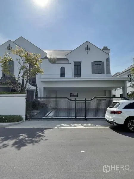 Detached House for sale in Saphan Sung, Bangkok - Full front elevation with gated driveway and covered parking.