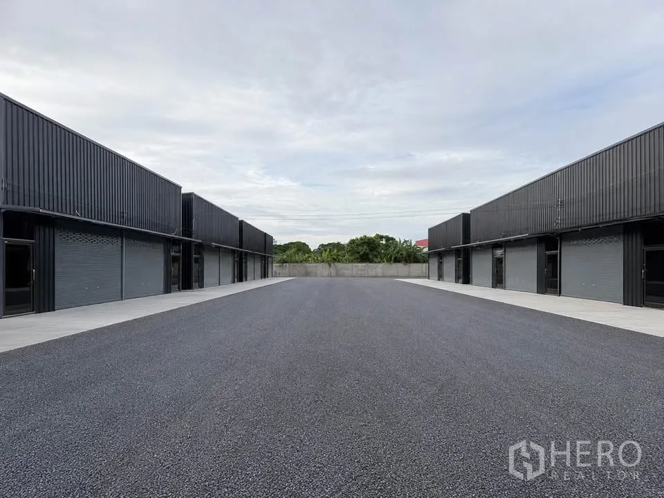 Warehouse for rent in Bang Kapi, Bangkok - Exterior view of warehouse rows facing a wide paved central yard for truck access.