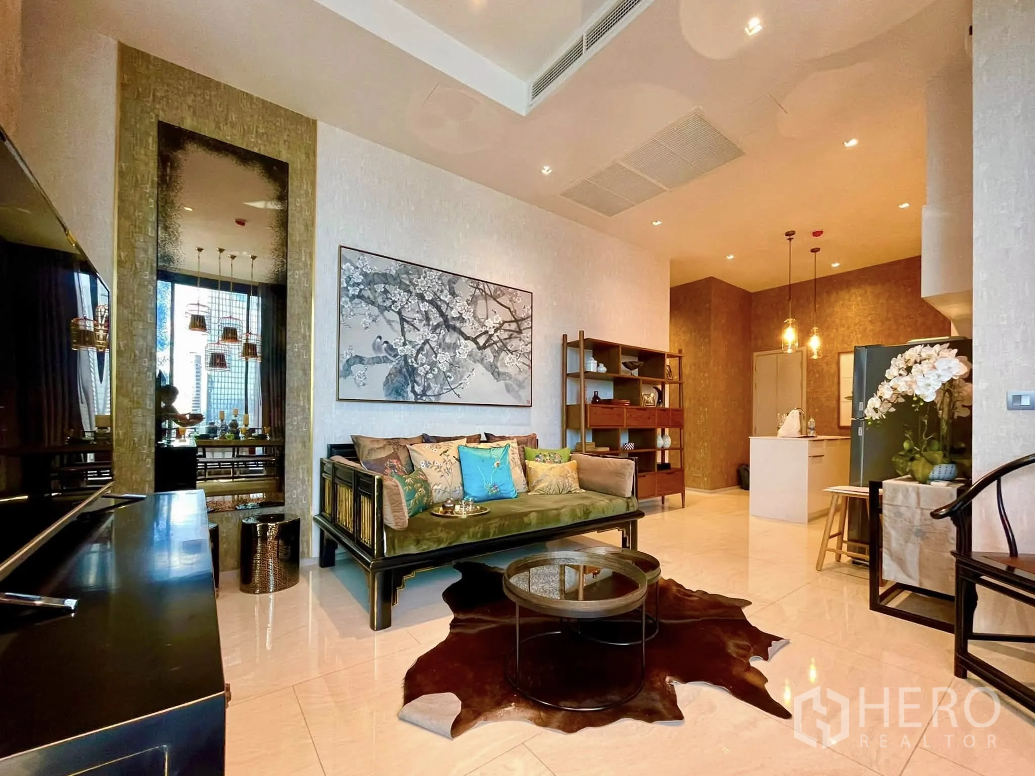 Condominium for rent in Bang Rak, Bangkok - Spacious living area with sofa, TV console and bookshelf.