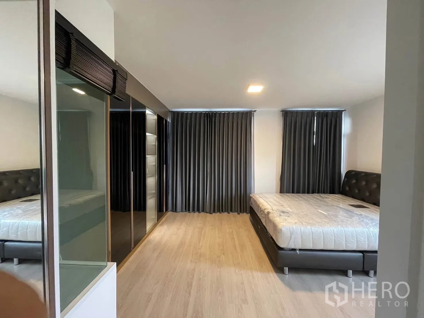 Townhouse for rent in Bang Phli, Samut Prakan - Master bedroom view showing two beds, wardrobes and blackout curtains.