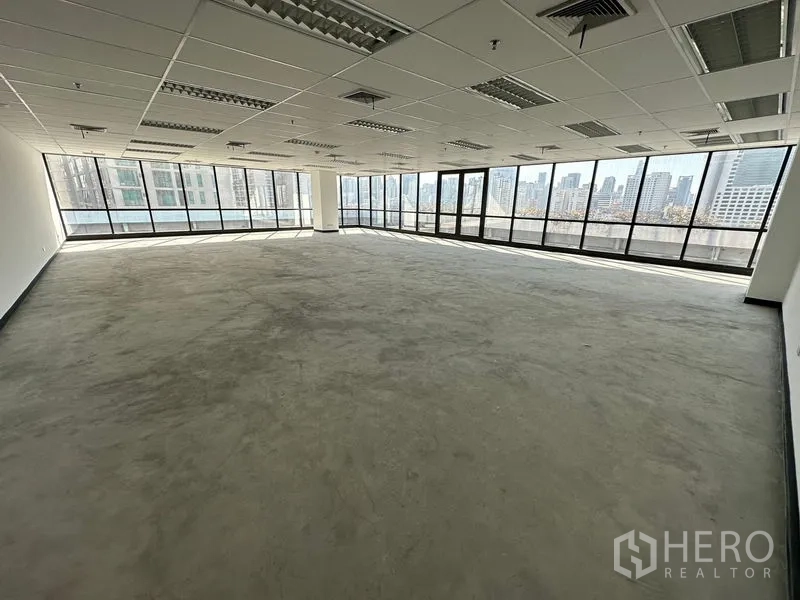 Office Space for rent in Watthana, Bangkok - Expansive open-plan office with wraparound glazing and a wide city panorama.